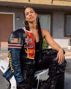 Alicia Keys posed on a bike 