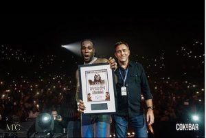 Burna Boy with a plague