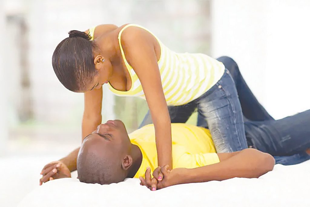 Passionate woman on top in intimate bedroom moment